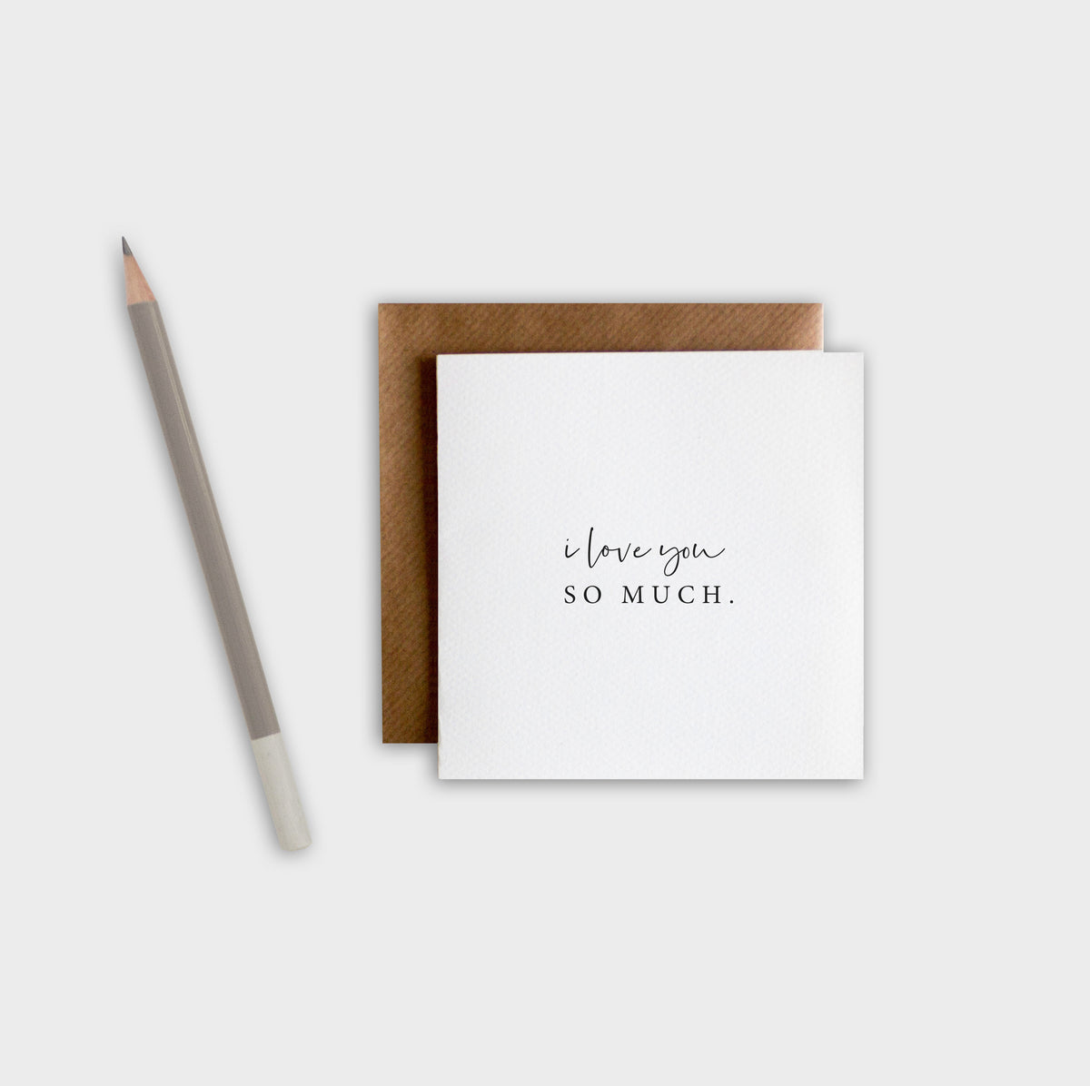 Greeting card with 'i love you so much' text and brown envelope on a white background