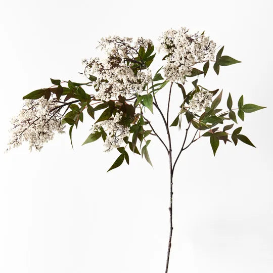 A white pepperberry spray with green leaves