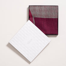 Folded sacarf with a patterned design on a white background