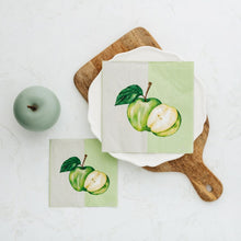 Wooden board with apple napkins on white plate