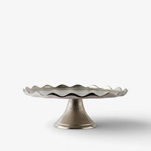 Decorative cake stand with wavy rim on a white background