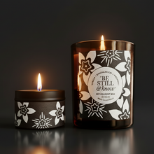 Two candles with decorative labels on a dark background