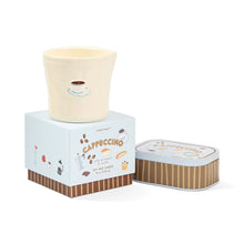 Candle with packaging labeled 'Cappuccino' on a white background