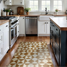 Modern kitchen with white cabinets, stainless steel appliances, and a patterned rug on wooden floor.