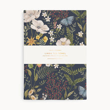 Linen tea towel with floral design on a white background