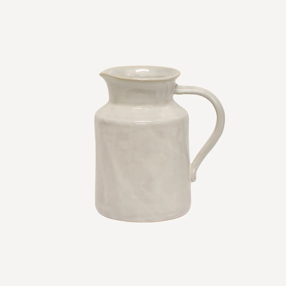 White ceramic pitcher on a light beige background