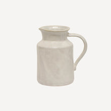 White ceramic pitcher on a light beige background