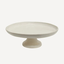 White ceramic cake stand on a white background