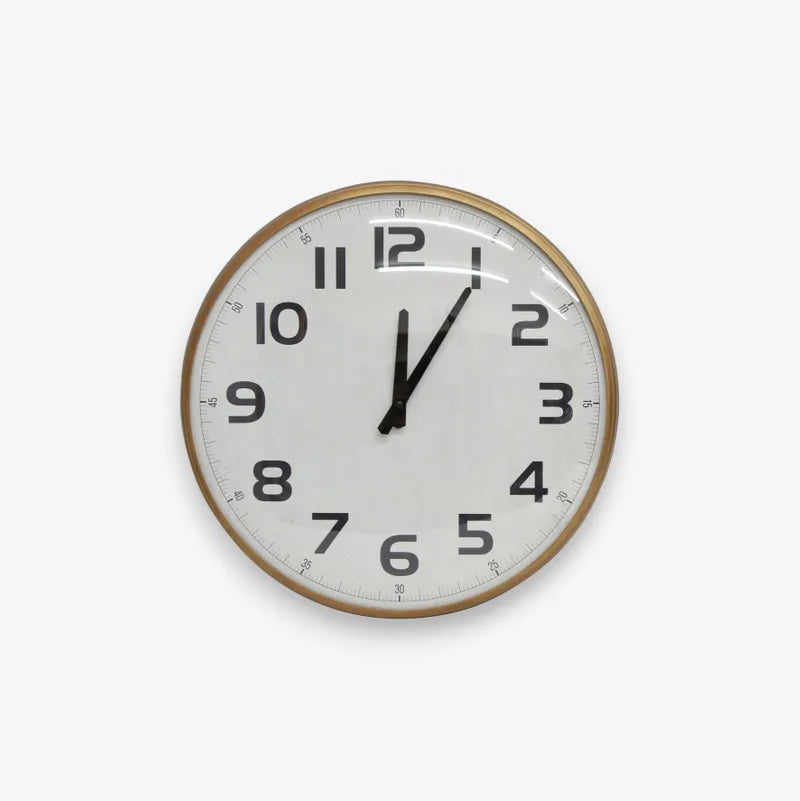 Round wall clock with a white face and black numbers on a light antiqued style background and frame.