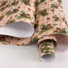 Roll of patterned paper with a checkered design on a white background