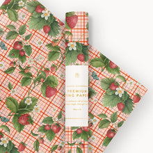 Packaging of strawberry-themed gift wrap paper with a roll on a white background