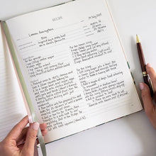 Handwritten recipe in a notebook with a pen on a white surface
