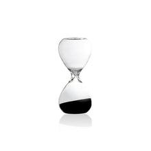 Clear hourglass with black sand on a white background