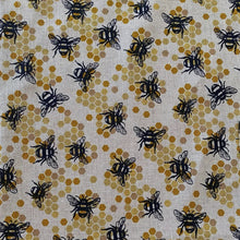 Fabric with black bee and honeycomb pattern on a beige background