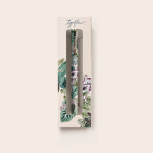 Floral-patterned pen in a decorative box on a light beige background