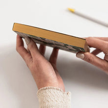 Person holding a notepad with a white background