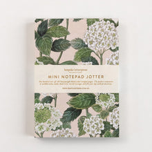 Mini notepad with floral design on a white background