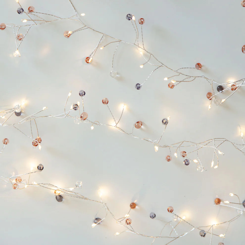 Warm white string lights threaded with jewelled beads