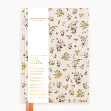 Floral patterned journal with visible brand name on a white background