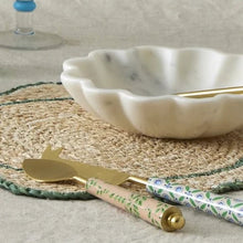 Marble bowl on placemat  with cheese utensils
