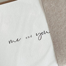 White card with 'me and you' text on a textured brown envelope