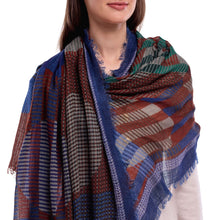 Person wearing a patterned scarf with blue, red, and brown colors on a white background