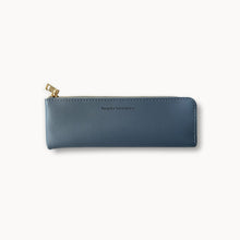 Blue pencil case with gold zipper on a white background