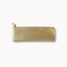 Gold pencil case with a brand name on a white background