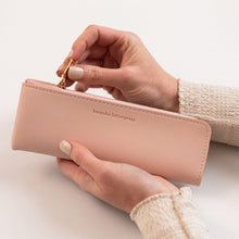 Person holding a pink pencil case