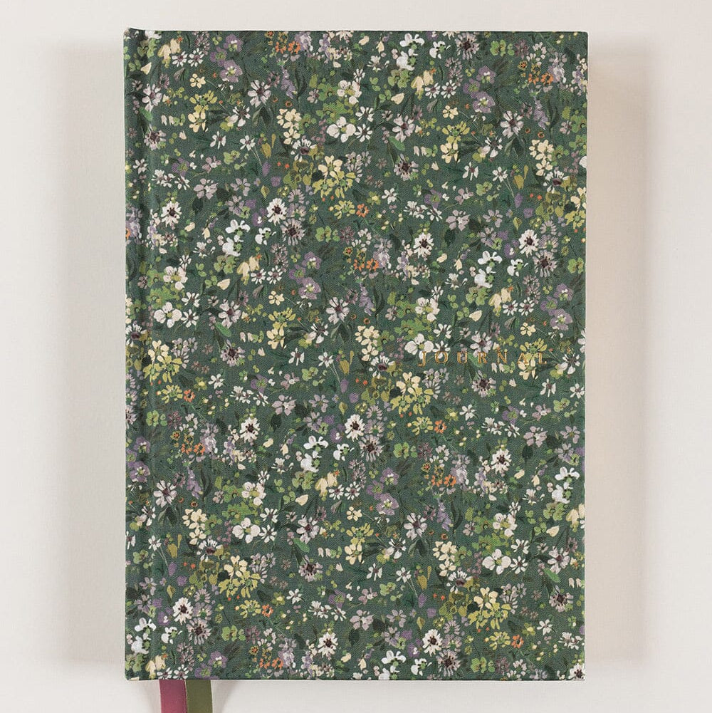 Floral-patterned notebook with a ribbon on a white background