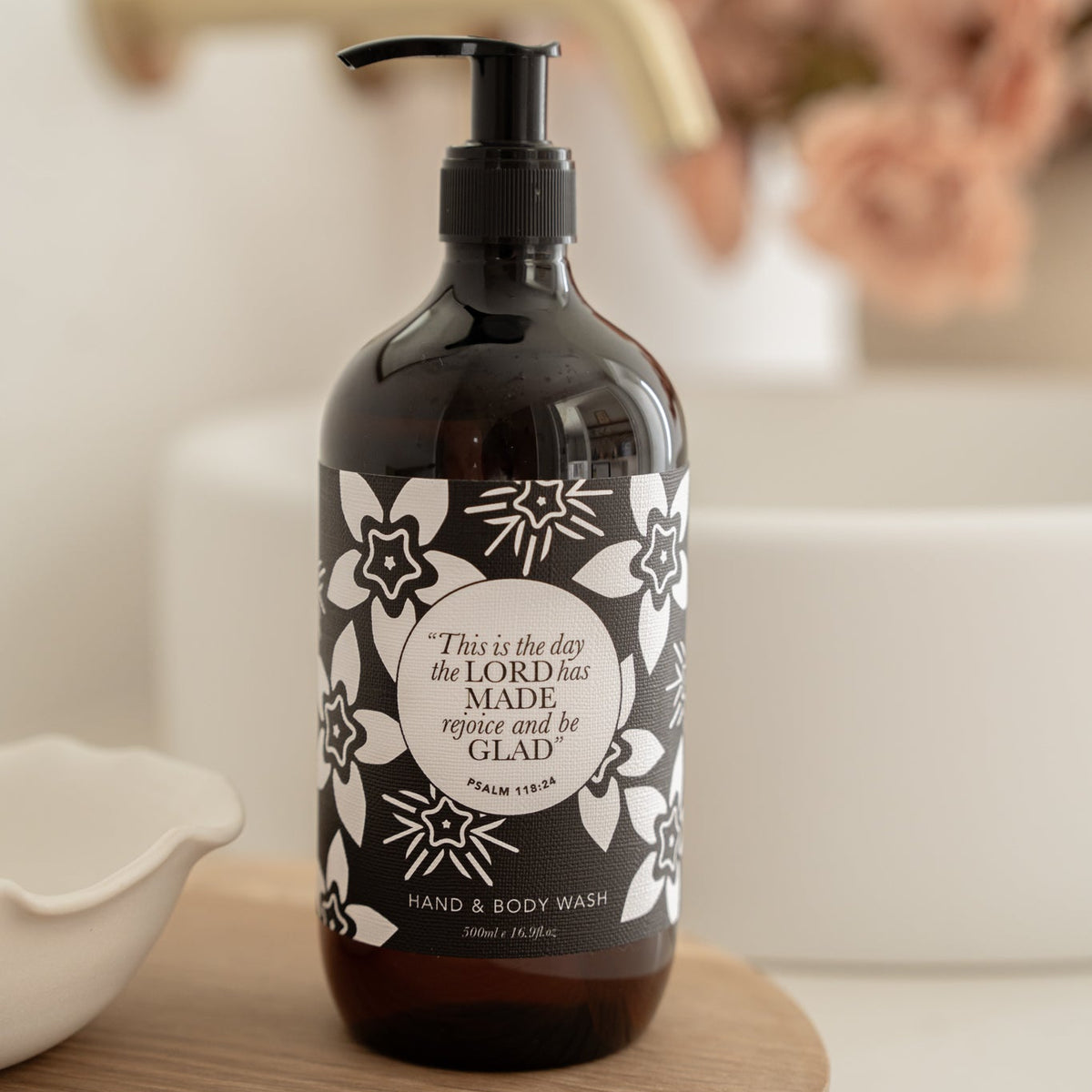 Well Versed Homes Signature Hand and Body Lotion on wooden board with Bible Verse from Provers on the label