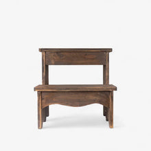 A rustic two-step wooden stool with a dark brown finish and handcrafted details, shown against a plain white background.