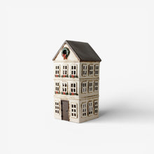 Ceramic tea light house with decorative elements on a white background
